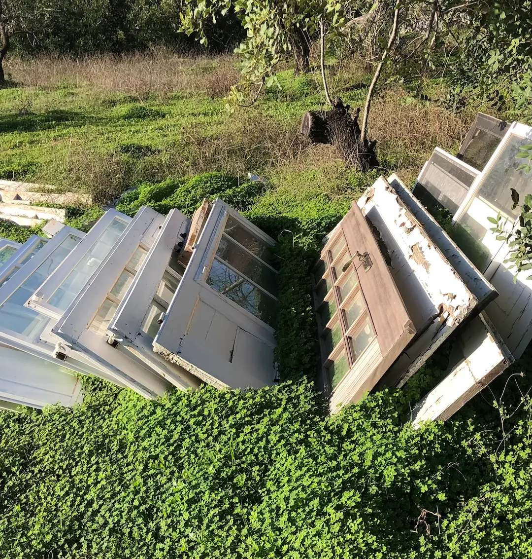 Old doors leaning against greenery. Finding a Good Builder in the Algarve: Why It’s a Struggle & How to Fix It Main Image artalgarve interiors